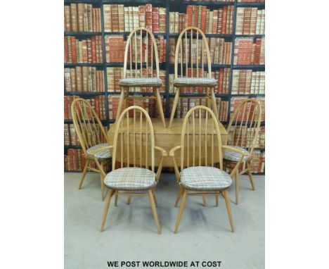 An Ercol light elm drop leaf table and six chairs including two carvers 