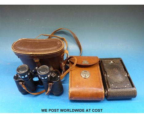 A cased pair of Hilkinson 8x30 binoculars together with a cased folding camera