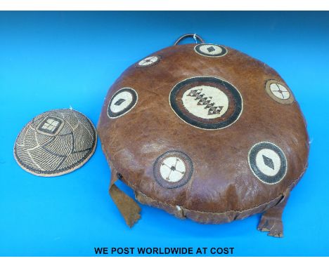 A Kenyan polo cushion together with a woven bowl