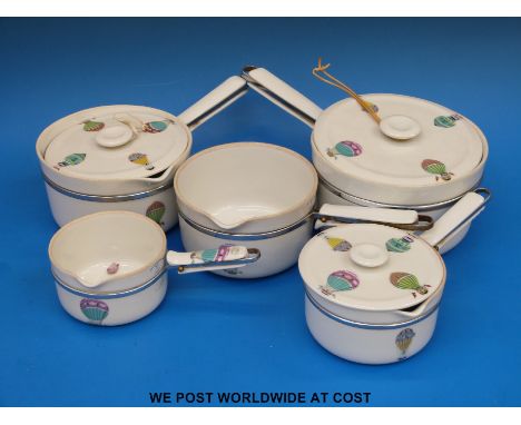 A collection of retro ceramic Limoges Aluminite Frugier saucepans with hot air balloon decoration, retailed by Asprey London