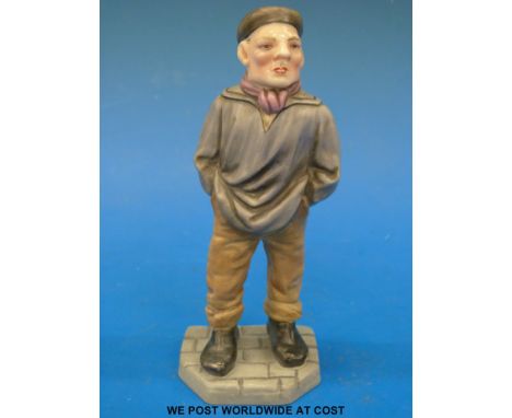 A Royal Worcester figure of a man with hands in pockets and a cap (14cm tall) 