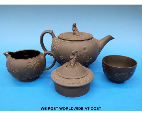 A Wedgwood black basalt figural teapot, sugar and milk jug