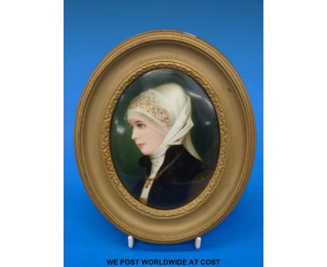 An KPM or Berlin ceramic painted oval plaque of a girl with white head-dress, inscription verso "Alt Deutsche Bingerfau Kanlb