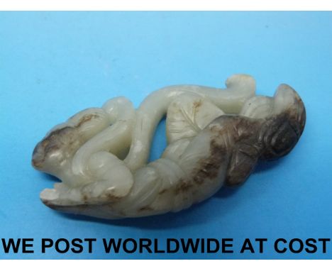 A 19thC Chinese jade carving of a courtesan with dark inclusions (6.3cm long)