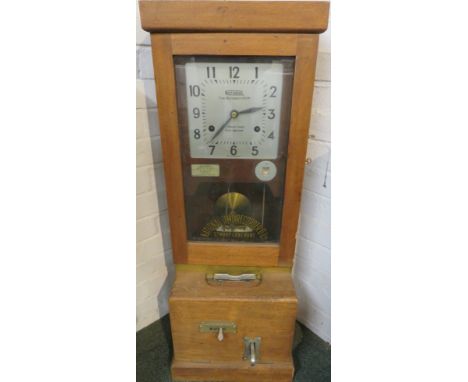 National Time Recorder Co Ltd St Mary Cray Kent England clocking-in machine in a light mahogany case, with day indicator and 