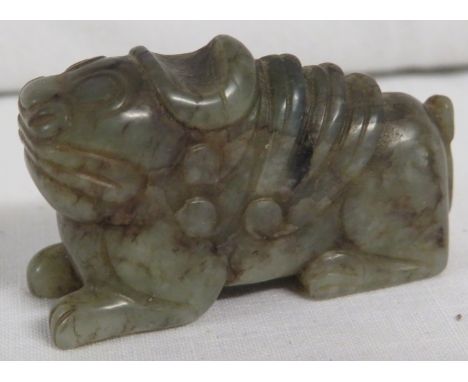 Miniature figure of a mythical dog carved from jade-type green stone, height 23mm, length 42mm