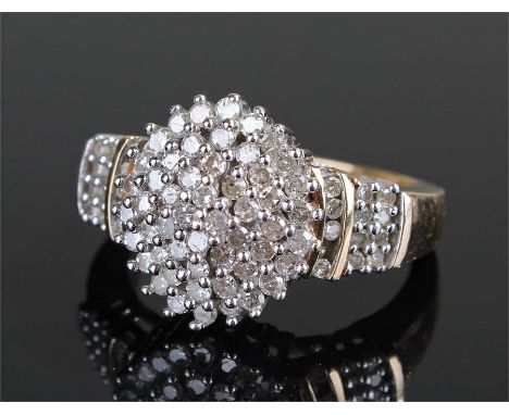 9 carat gold diamond set ring, the head formed as a wide diamond set oval, diamonds to the shoulder, ring size Q 1/2