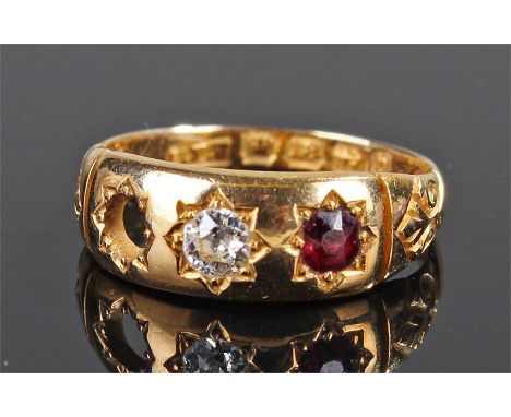 18 carat gold diamond and ruby ring, the central diamond with a ruby to the side, the opposing side missing the stone, ring s