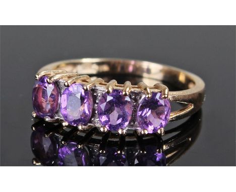 9 carat gold ring, set with purple stones