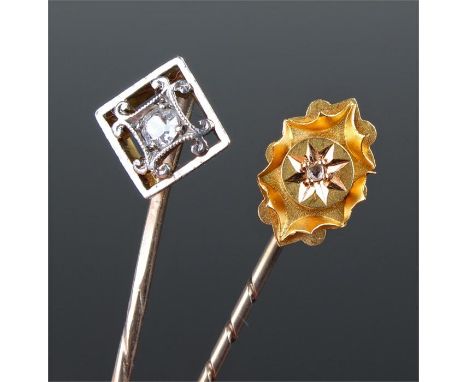 Two diamond and gold stick pins, each set with a diamond, (2)