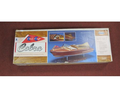 A Dumas Boats Wooden Kit #1232 Model of a 1955 18' Chris Craft Cobra, length 27", beam 9¾", scale 1:8th, the kit features dou