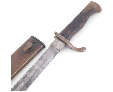 A First World War Period German Army sawback bayonet, by Alex Coppel Solingen, with carved wood grips and original metal scab