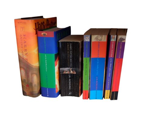 Hardback and paperback editions of Harry Potter, by J K Rowling