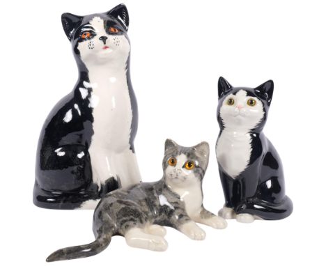A Winstanley grey tabby kitten, a large Price's black and white cat, 30cm, and a smaller cat