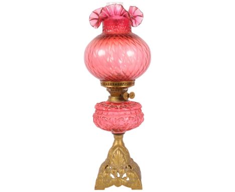 A Victorian Duplex brass cranberry glass oil lamp, with original moulded cranberry glass shamrock font, frilled cranberry gla