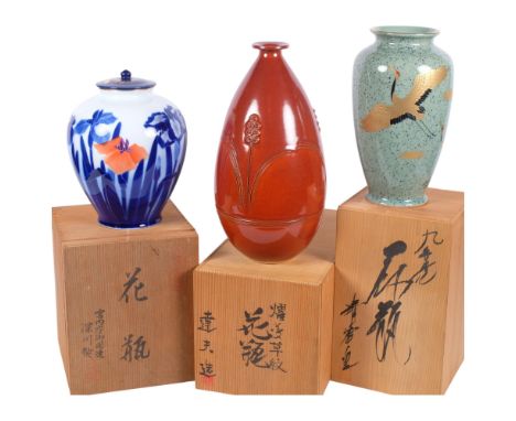 A Japanese ceramic jar and cover, with stylised floral design, signed, 22cm, a vase with gilded flying cranes, and another wi