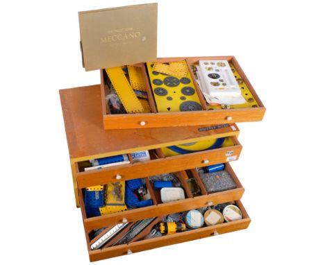 A wooden Meccano chest of 4 drawers, containing Meccano, and a folder of special model leaflets