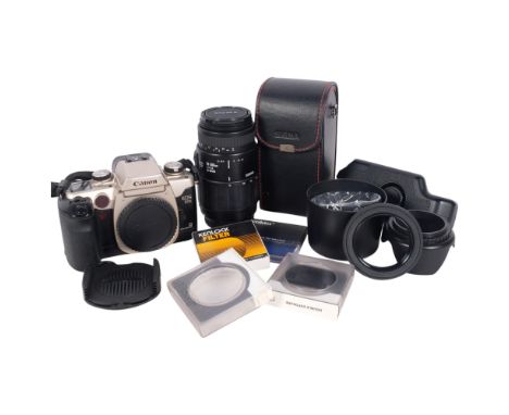 A Canon EOS 50E camera body, together with a Sigma 70-300mm 1:4-5.6 DL macro lens, lens cover and other accessories