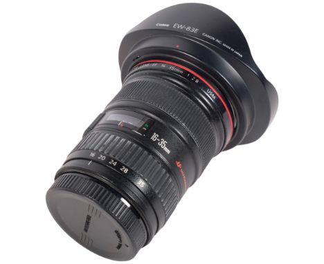 A Canon Zoom Ultrasonic EF16-35mm 1:2.8 camera lens, serial no. 97002254, with a Hoya 77mm protector, and a Canon EW-83E