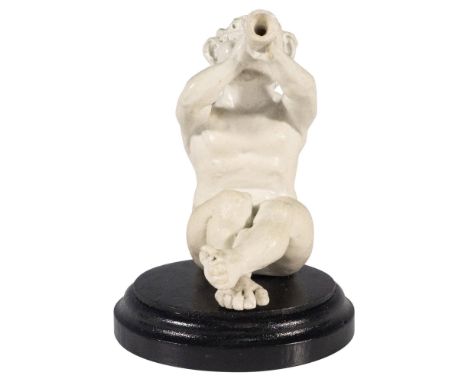 Stoneware modelled seated creature playing the horn in a matt white glaze. Placed on a wood base. Incised Martin Bros, London