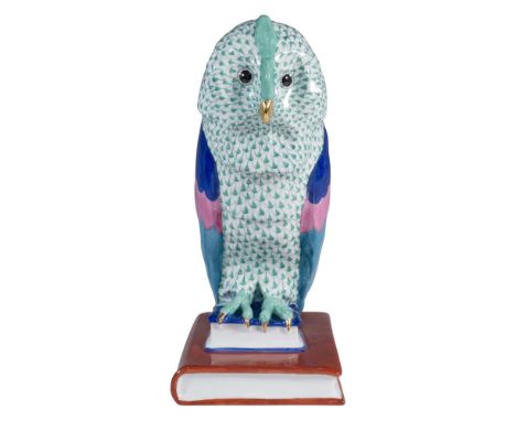 A tall, curious owl is depicted perched on two books, adorned in bright colors of pink, blue, red, and green, accented with g