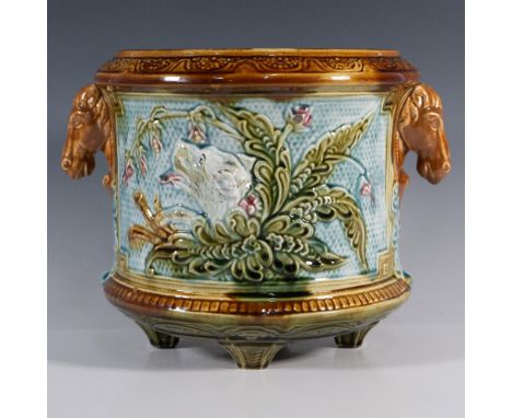 A handsome planter with figural handles and a plaque feature between them. The plaque showcases a dog's head surrounded by bo