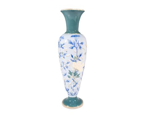 A footed flower vase with a cyan colored neck and bottom. The body decorated in a light blue glaze with blue painted yarrow-l