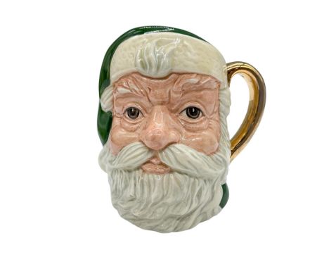 Small character jug of Saint Nicholas in green and white. Hand painted gilt formed the handle. Marked: Royal Doulton backstam