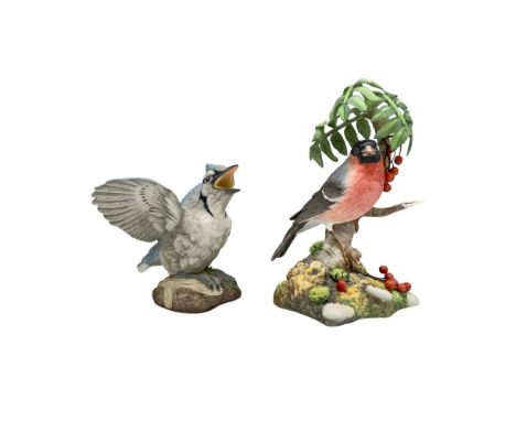 A vibrant blue jay with wings spread and a tranquil bullfinch perched on a tree trunk. Matte finish. Boehm backstamp. Dimensi
