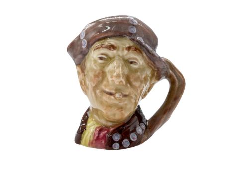 Figural jug in a brown coat, yellow and red tunic, light brown hat. Decorated with painted white-purple buttons. Plain light 