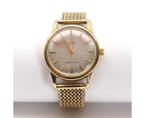 A gentlemen's 9ct gold Omega automatic 'Seamaster',with a 33.60mm circular case. A silvered dial with raised gilt batons and 