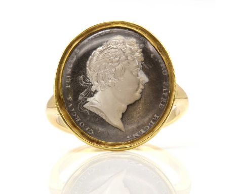 A George IV gold, glass sulphide cameo ring, by Rundell, Bridge &amp; Rundell, c.1815,the oval glass sulphide cameo depicting