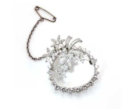 A diamond set floral circle or wreath brooch/pendant,with a line of graduated brilliant cut diamonds, claw set to form the sl
