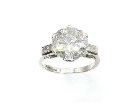 A single stone diamond ring,with diamond set shoulders, with a brilliant cut diamond with an estimated weight of approximatel