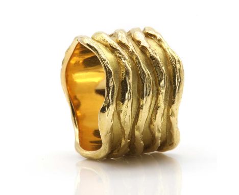 A wavy gold 'sleeve' ring designed by K R Hooper of Hooper Bolton Ltd., c.1973, and made by Leo De Vroomen,the flat section s