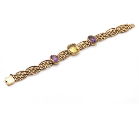 An Edwardian four row citrine and amethyst gate bracelet,with a cushion cut citrine, claw set to the centre of a plain collet