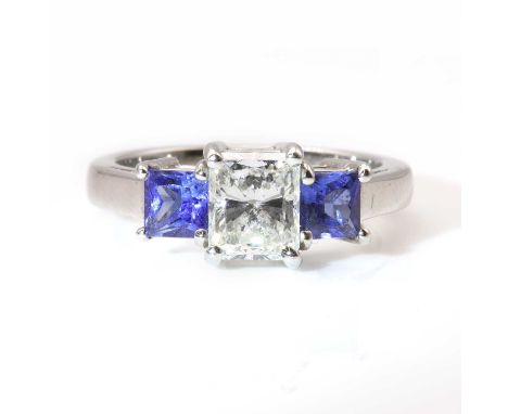 A three stone diamond and sapphire ring,with a radiant cut diamond, with an estimated weight of approximately 0.97ct, with a 