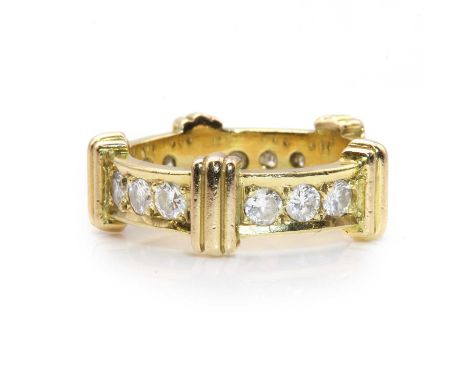 A gold diamond set band ring, sets of three brilliant cut diamonds, grain set to the band, with triple raised bands between e