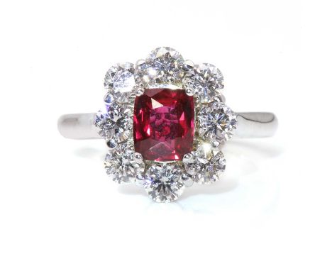 An unheated ruby and diamond cluster ring, with a cushion cut unheated ruby, with a stated weight of 1.07ct, four claw set to