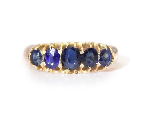 An Edwardian rose gold graduated five stone sapphire boat shaped ring,with five graduated oval mixed cut and old eight cut sa