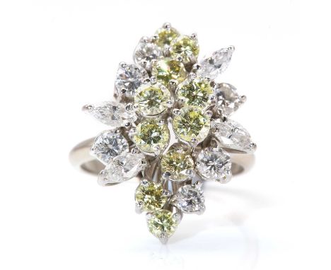 A diamond set lozenge shaped cocktail ring,with dispersed cluster of graduated fancy brilliant cut diamonds to the centre. Ou