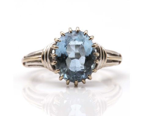 An 18ct white gold single stone aquamarine ring, by Albion Craft, c.1960,with an oval mixed cut aquamarine claw set to a wire