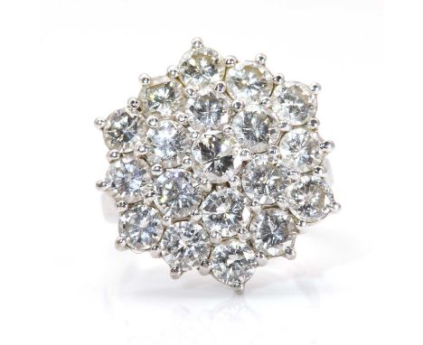 A diamond set hexagonal cluster ring,with three tiers of brilliant cut diamonds, all claw set to an hexagonal head. A shallow