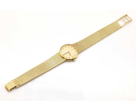 A ladies' 18ct gold Omega mechanical bracelet watch, c.1966,with a circular 24mm case. A champleve dial with raised gilt and 