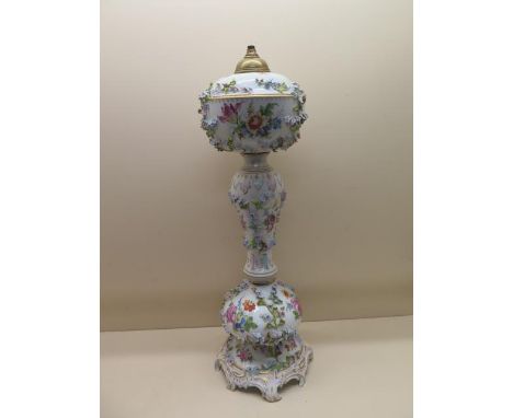 A Continental floral encrusted porcelain oil lamp stand - Height 61cm - some foliate losses and firing crack but generally go