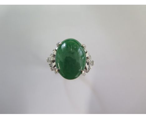 A 900 platinum green Jade and diamond ring size L/M - approx weight 10 grams - Jade approx 18mm x 13mm x 5mm - in good condit