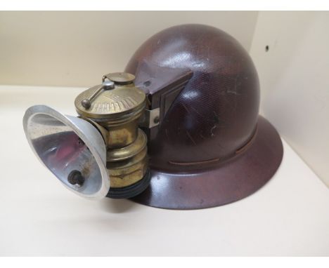 An M.S.A Skullgard American Mine Safety Appliances Co - helmet size 7 1/8 with autolite lamp 