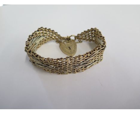 A 9ct yellow and white gold bracelet - 21mm wide - hallmarked London 1973 S&amp;K - approx weight 42 grams - in good conditio