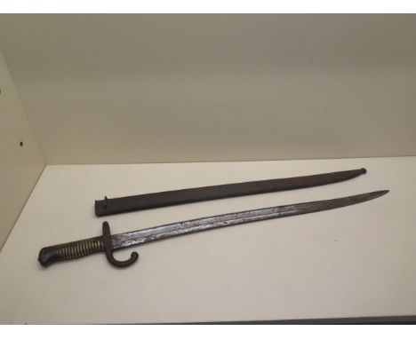 A 19th century bayonet/sword with a curved blade - Total length 69cm with scabbard, some rusting and pitting 