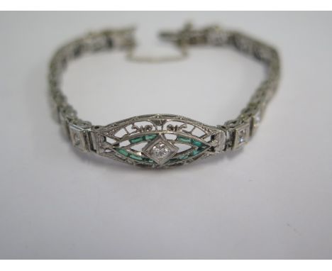 A white metal Art Deco diamond and emerald bracelet - head size 24mm x 10mm - approx weight 9.4 grams - some wear and missing